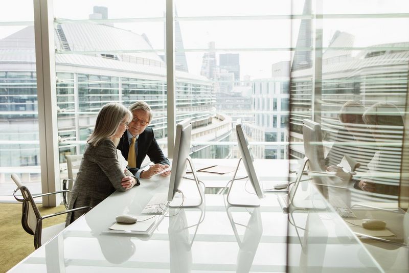 Older business people reading and analysing